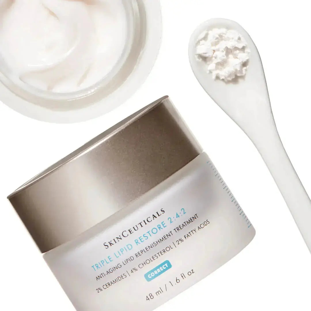 Skinceuticals Triple Lipid Restore 242 cream jar with cream texture and white spatula on white background