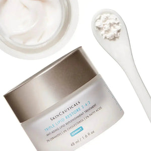 Skinceuticals Triple Lipid Restore 242 cream jar with cream texture and white spatula on white background