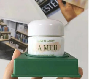 La Mer moisturizing cream wholesale in white jar with green packaging held in hand by Think AtoZ Ltd