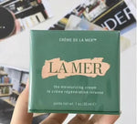 La Mer moisturizing cream 1oz green box held in hand with product details visible