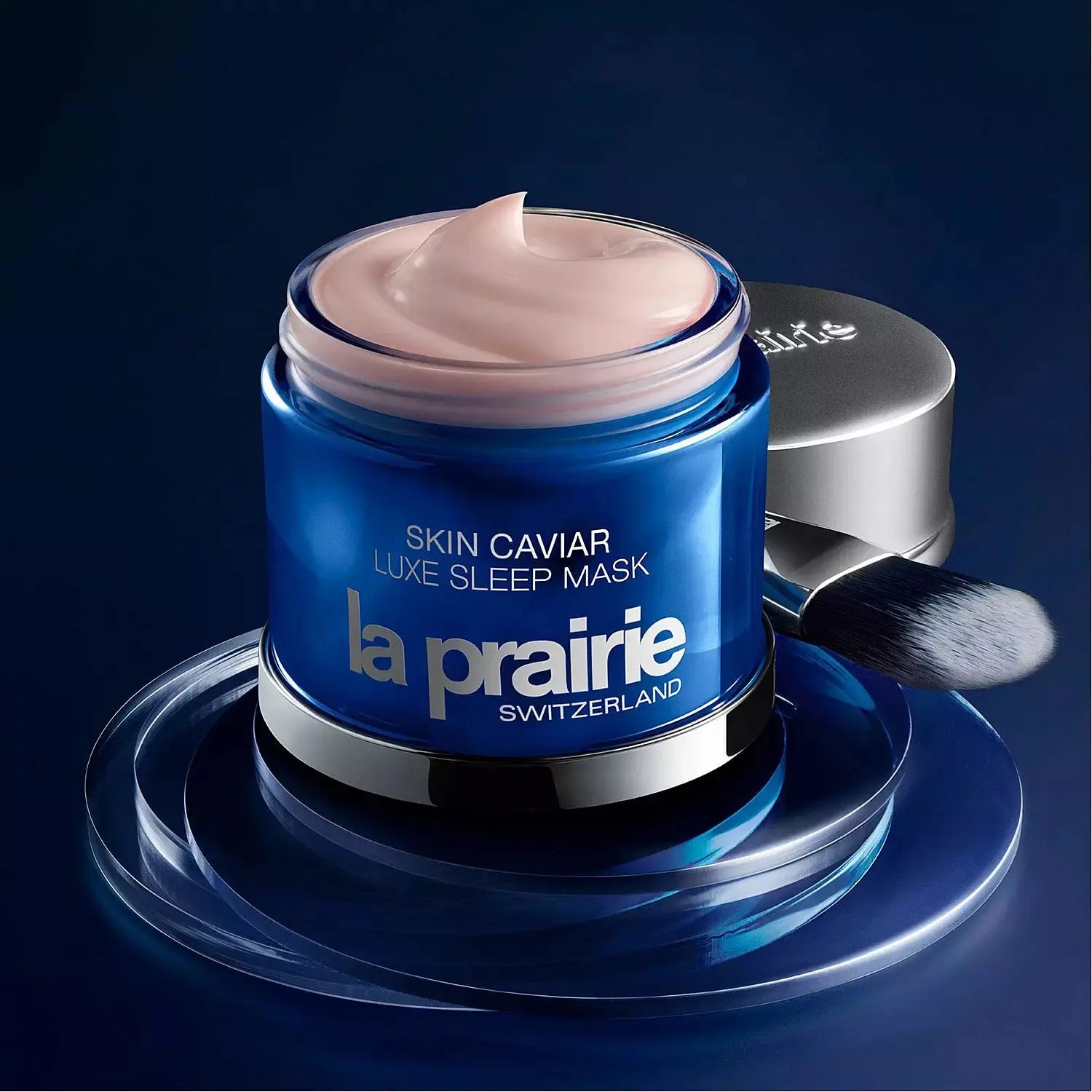 La Prairie Skin Caviar Luxe Sleep Mask wholesale jar with cream and applicator brush on blue surface