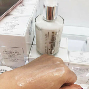 Sisley Ecological Compound day night cream bottle with cream applied on hand showing texture and packaging