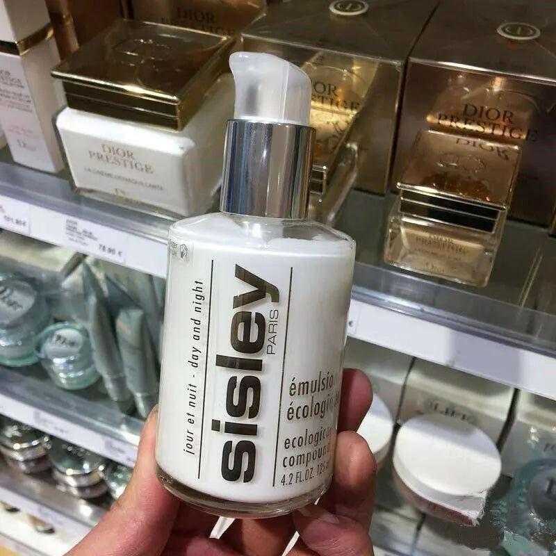 Sisley Ecological Compound day night cream bottle with pump dispenser held in hand in skincare store