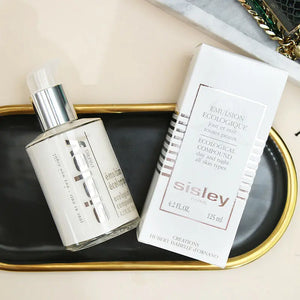 Sisley Ecological Compound day night cream bottle and box on black and gold tray by ThinkAtoZ