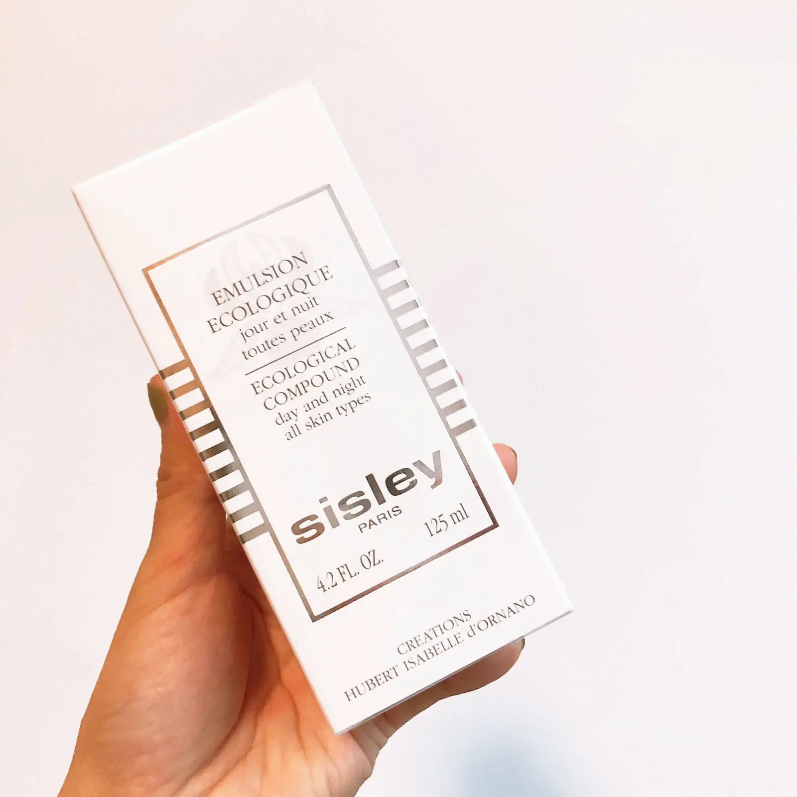 Sisley Ecological Compound day night cream box held in hand for all skin types 125 ml