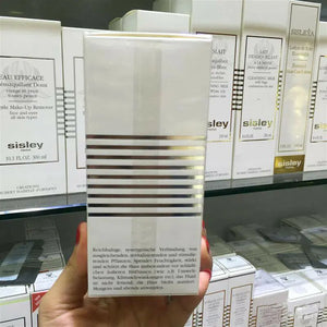 ThinkAtoZ Sisley Ecological Compound day night cream packaging held in hand with skincare products on store shelf